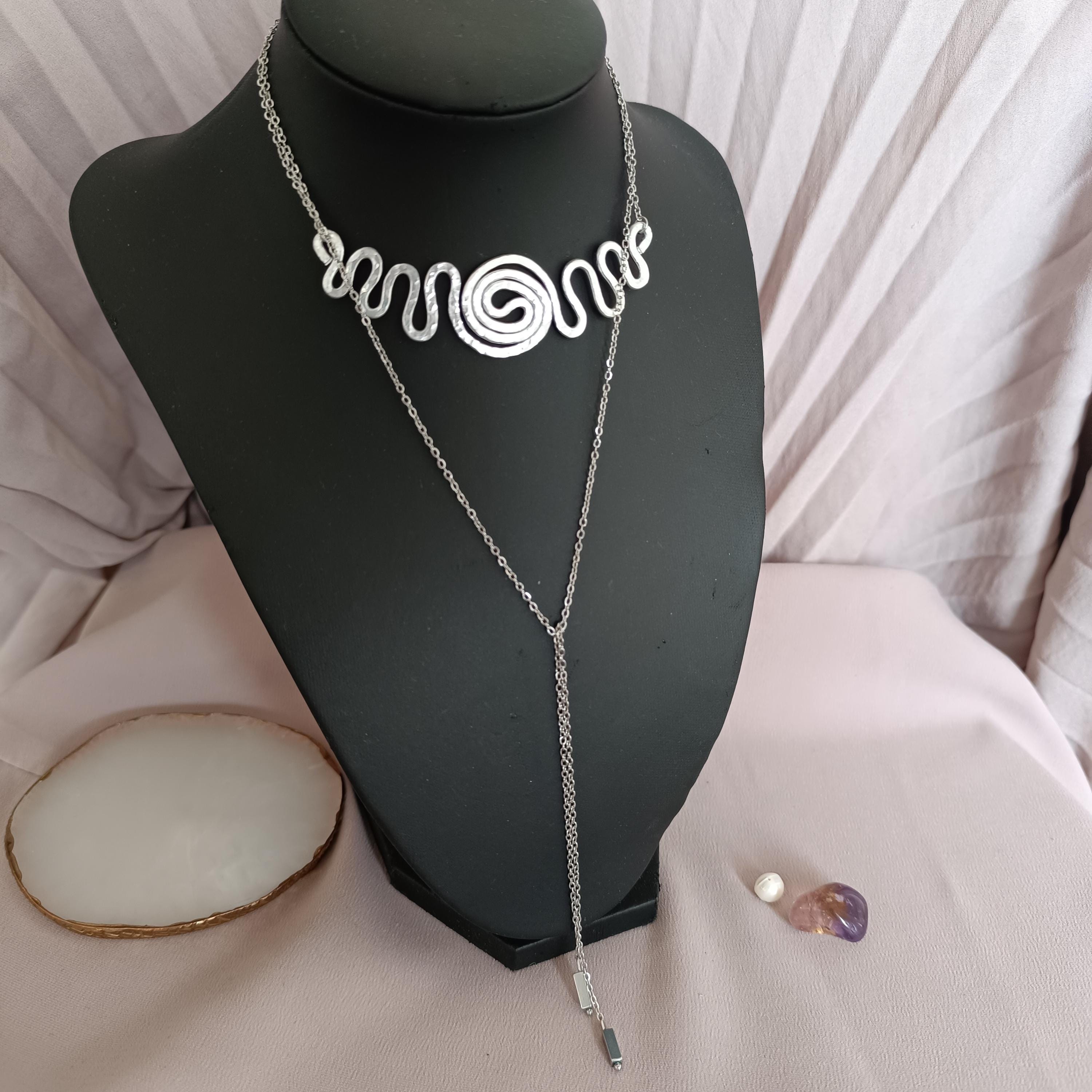 Versatile choker necklace worn with the spiral at the front and adjustable chain draped down.