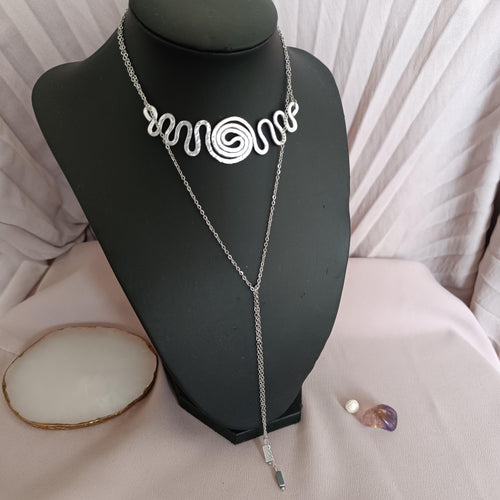Versatile choker necklace worn with the spiral at the front and adjustable chain draped down.