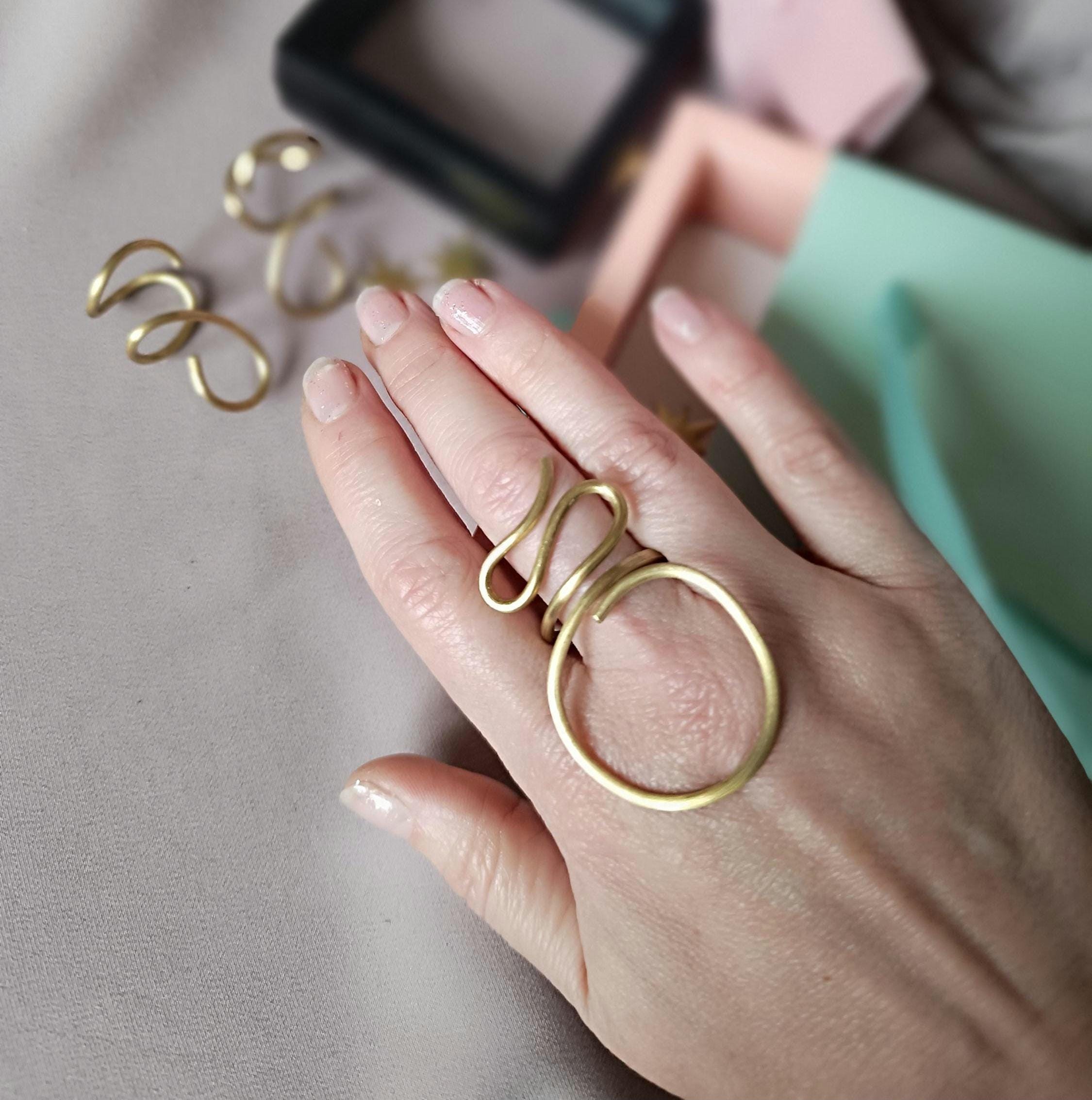 Large minimalist brass ring, handcrafted and adjustable. Open design, perfect for both men and women. Stylish statement jewelry with a bold modern look. Ideal for everyday wear or special occasions. Comes in elegant gift packaging.
