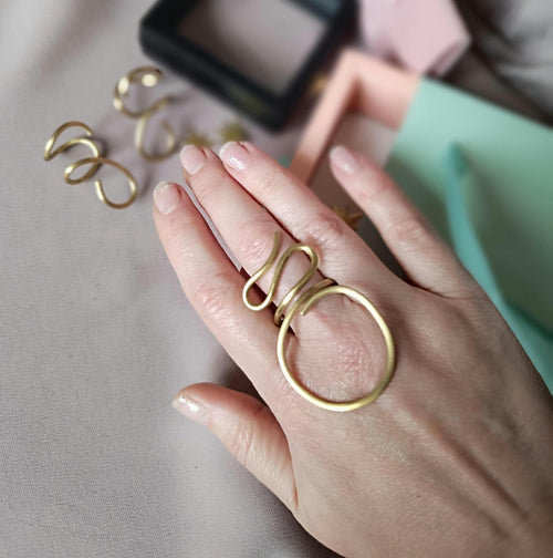 Large minimalist brass ring, handcrafted and adjustable. Open design, perfect for both men and women. Stylish statement jewelry with a bold modern look. Ideal for everyday wear or special occasions. Comes in elegant gift packaging.