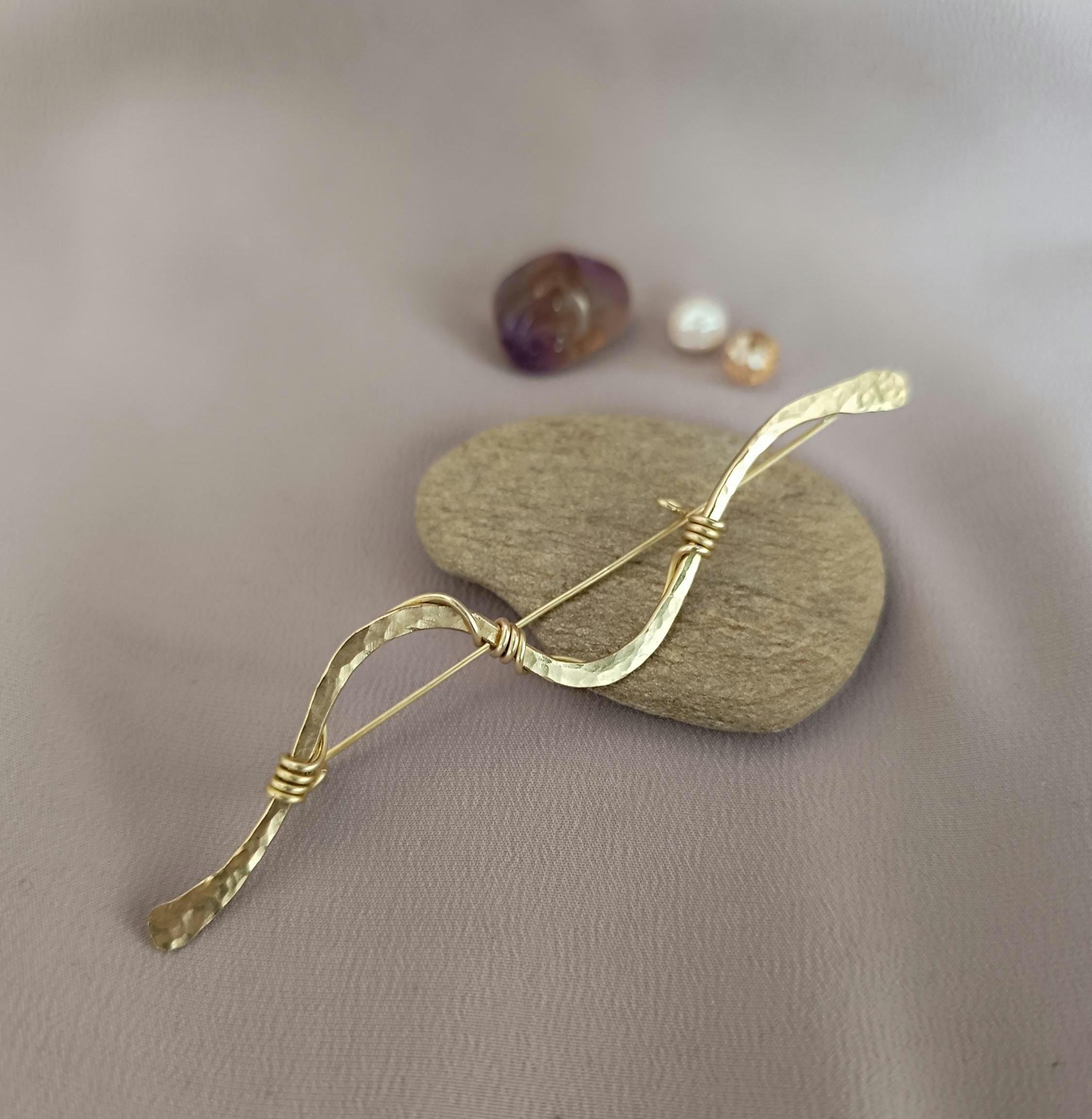 Handmade brass wave shawl pin with a minimalist wire-wrapped design