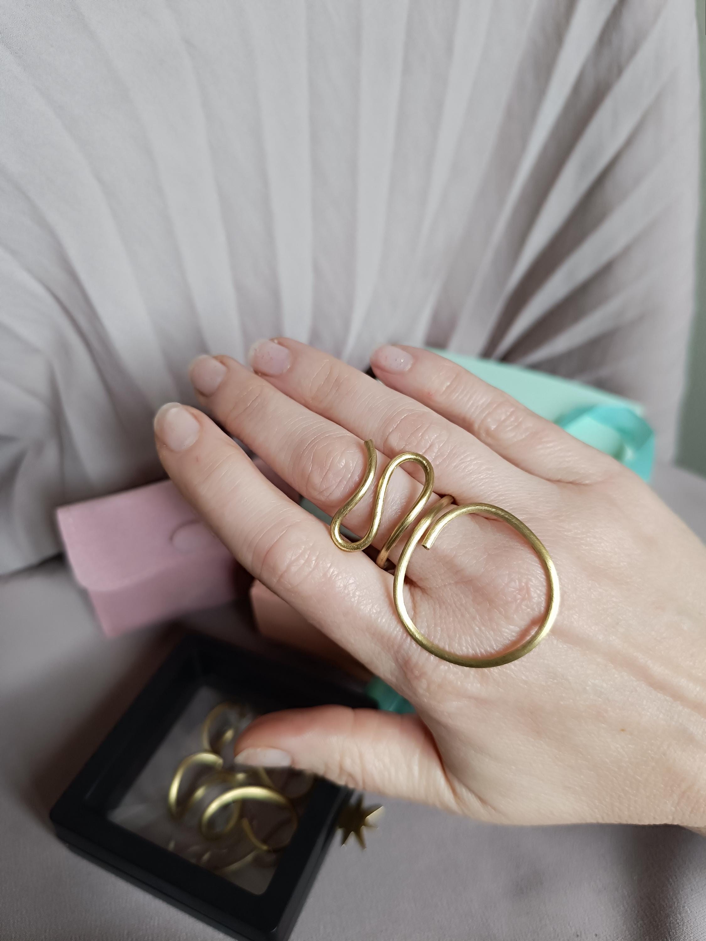 Large minimalist brass ring, handcrafted and adjustable. Open design, perfect for both men and women. Stylish statement jewelry with a bold modern look. Ideal for everyday wear or special occasions. Comes in elegant gift packaging.